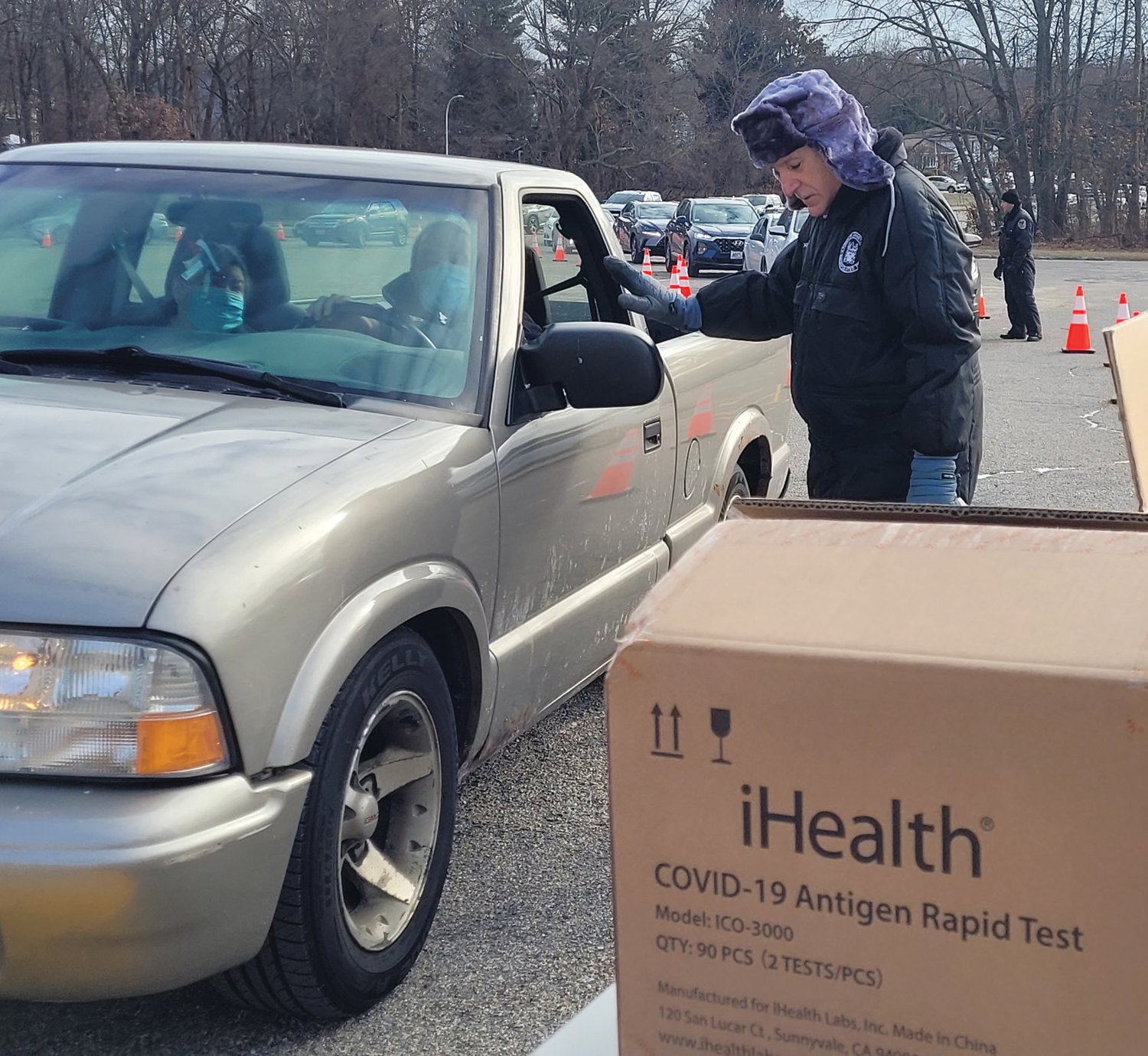MAYORAL MISSION: Town officials gathered several weeks ago in the Johnston High School parking lot to distribute thousands of test kits. Johnston Mayor Joseph M. Polisena braved the cold to help hand out the tests.